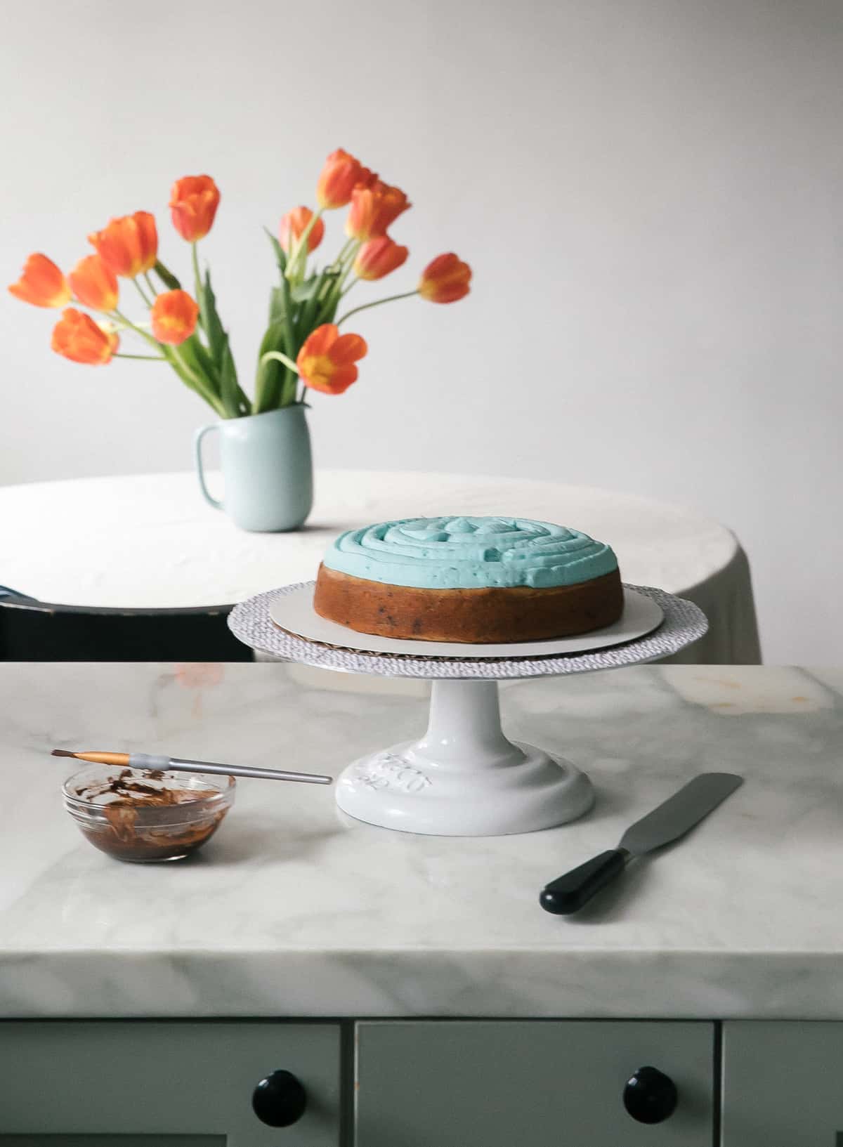 Speckled Egg Cake on counter being decorated. 