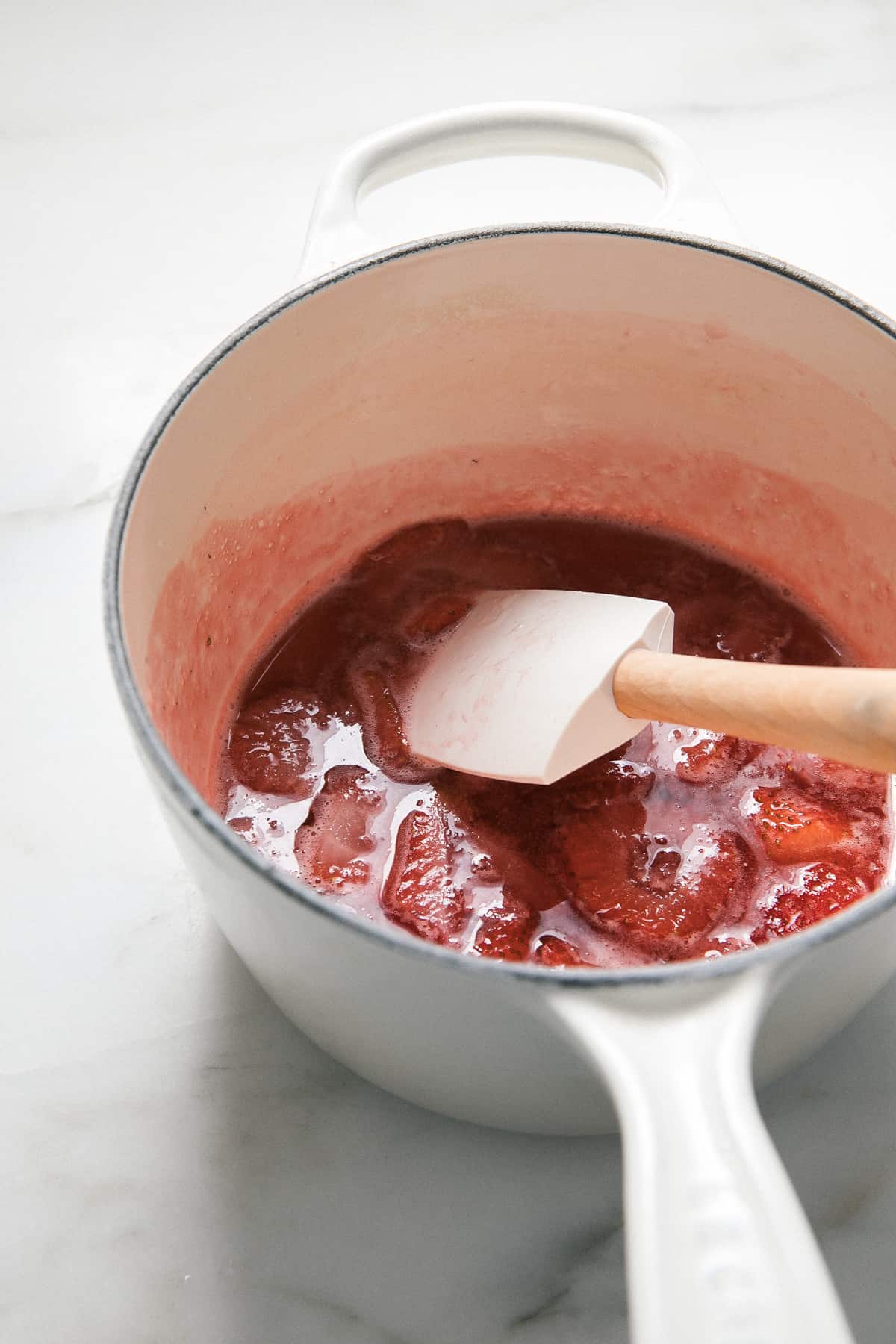Strawberry syrup in a saucepan.