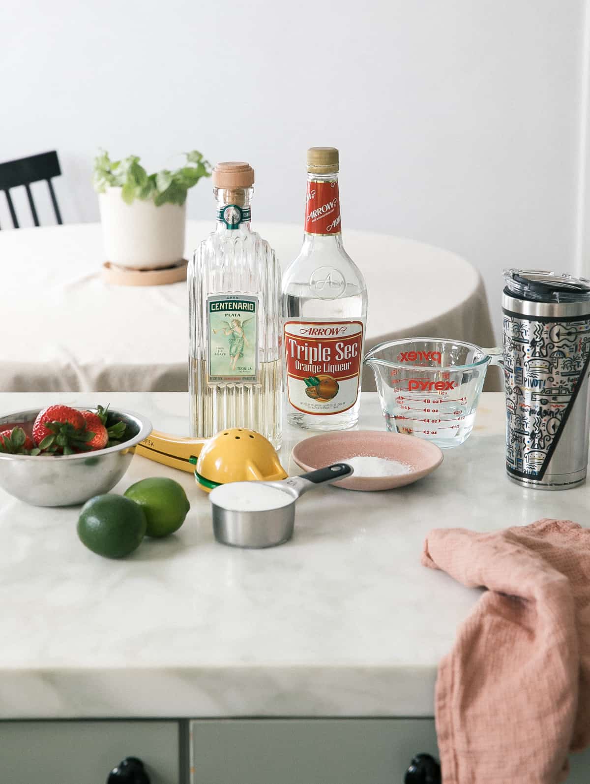 Ingredient shot of tequila, limes, strawberries.