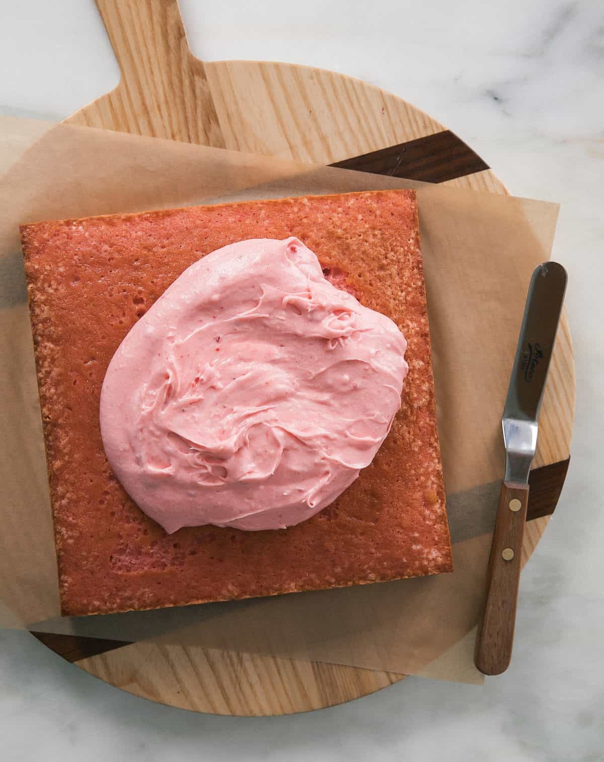 strawberry cake with blob of frosting on top