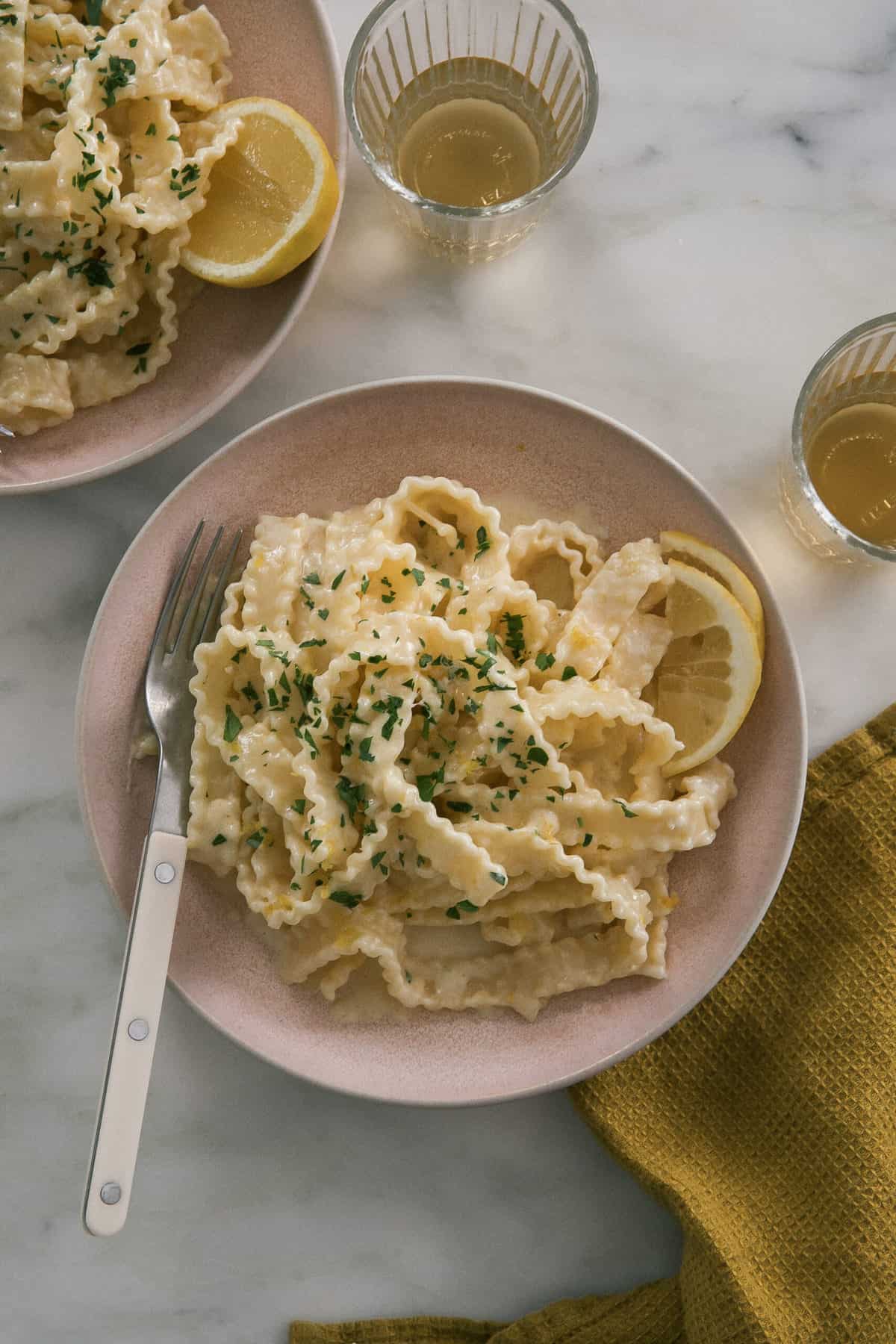Pasta al Limone in bowl with lemons. 