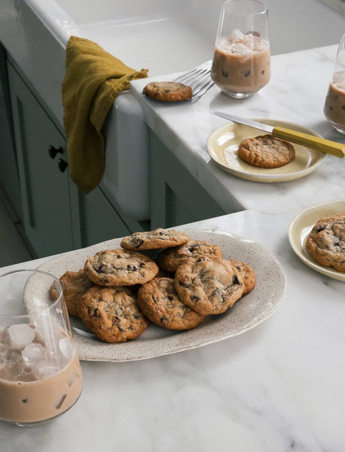 Banana Chocolate Chip Cookies on a plate with iced coffees