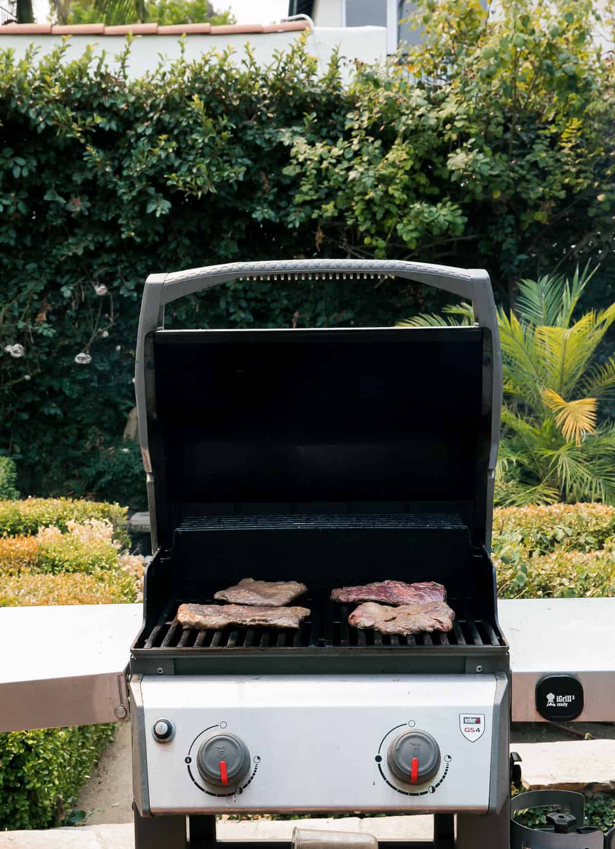 Meat being grilled outside. 