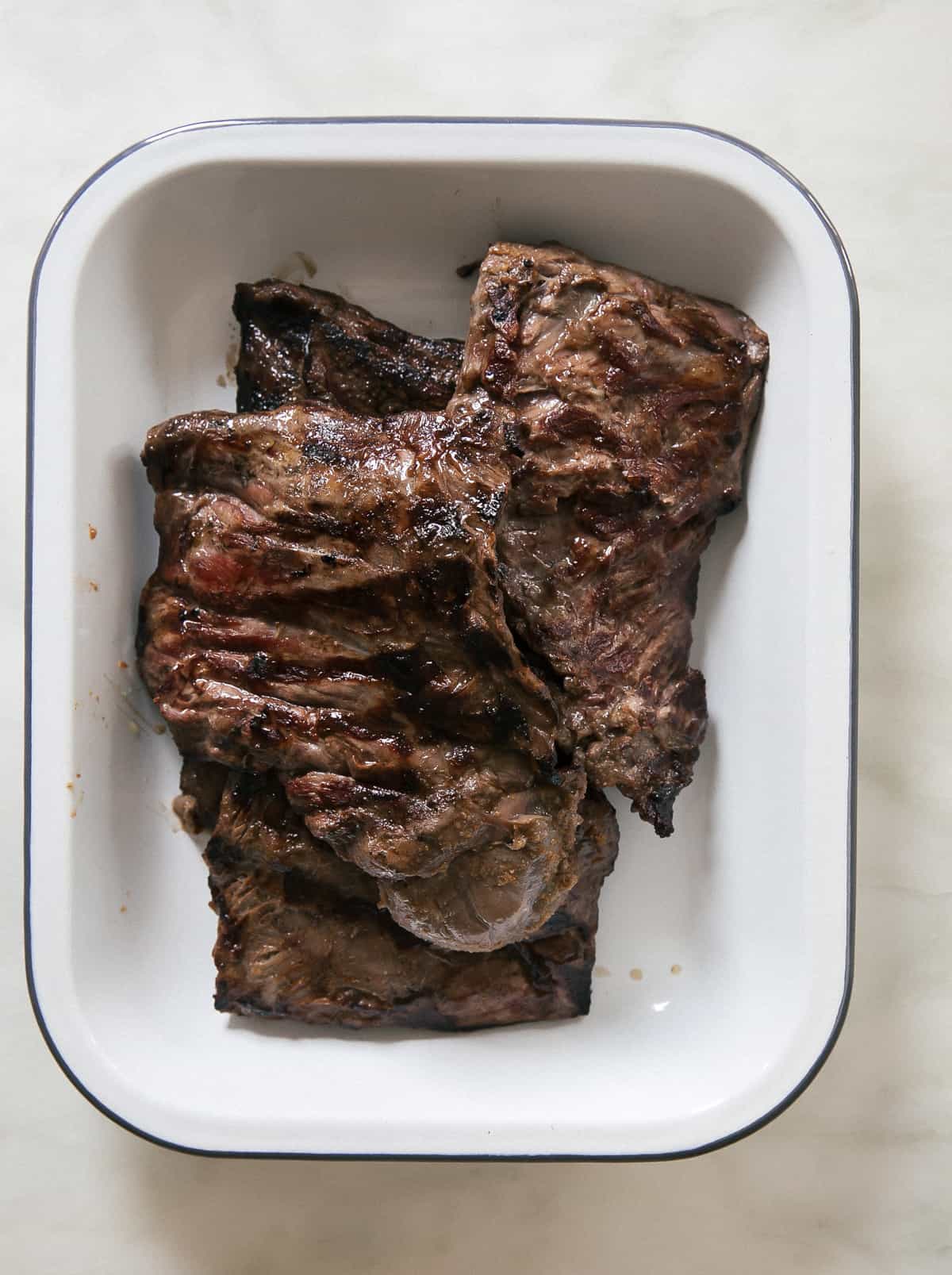 Grilled meat in a baking dish. 