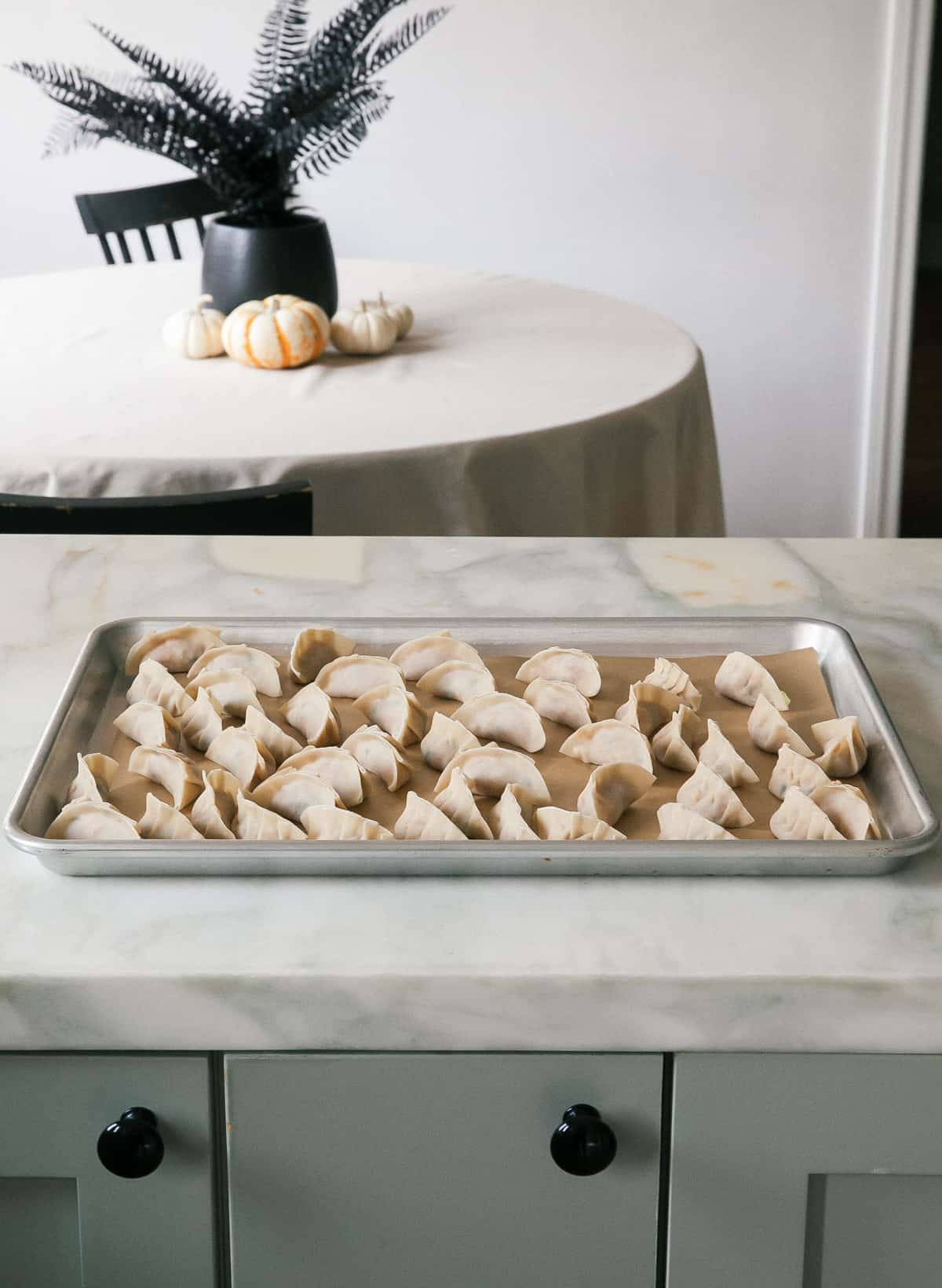 Potstickers on baking sheet, pre-cooked.