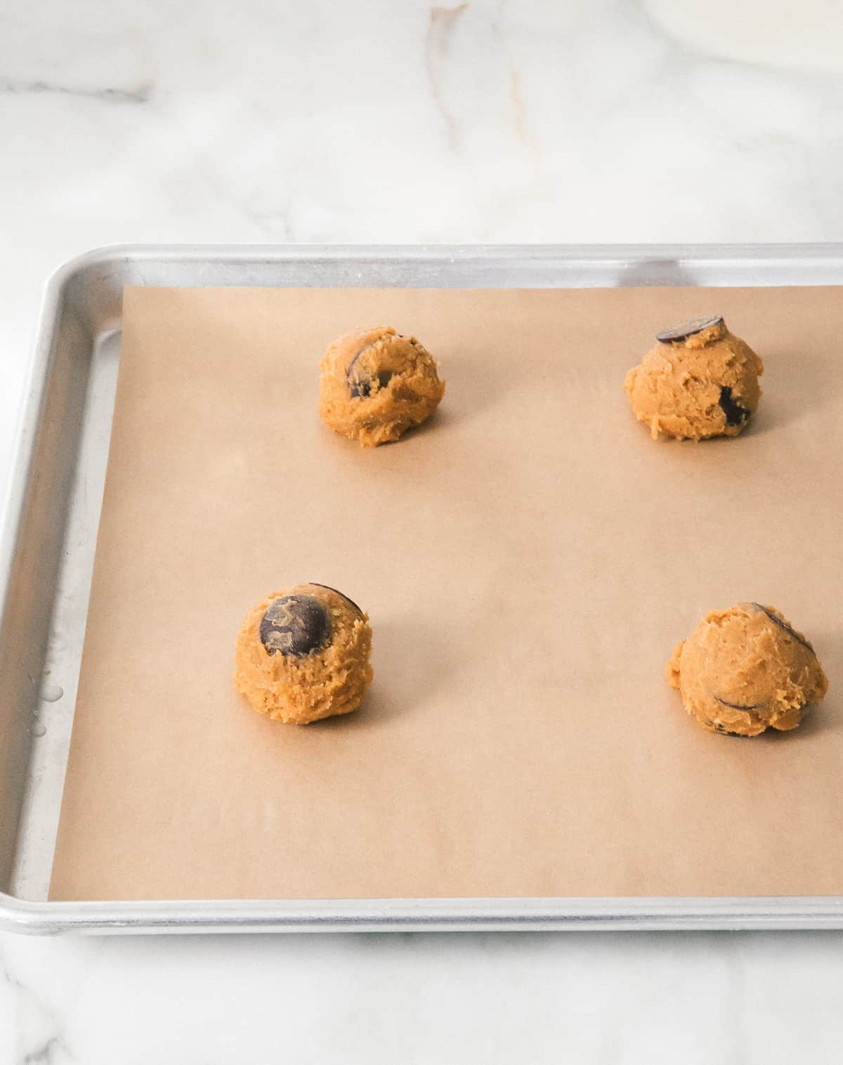 Pumpkin Chocolate Chip Cookies dough on a baking sheet