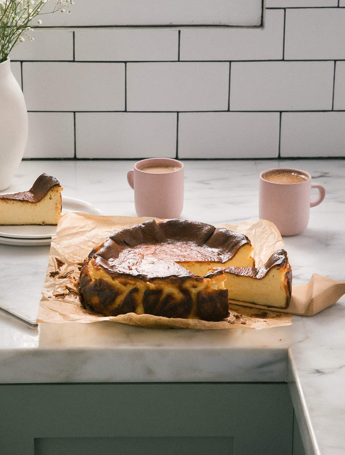 Basque Cheesecake on counter sliced. 