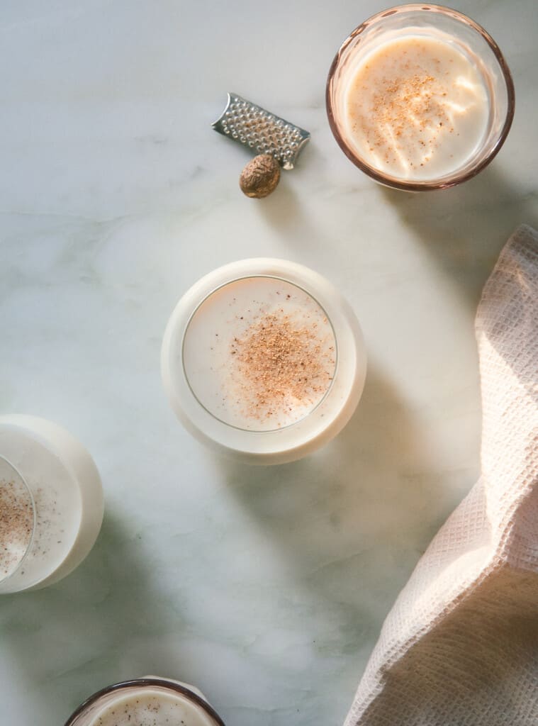 Coquito in glasses with grated nutmeg on top. 