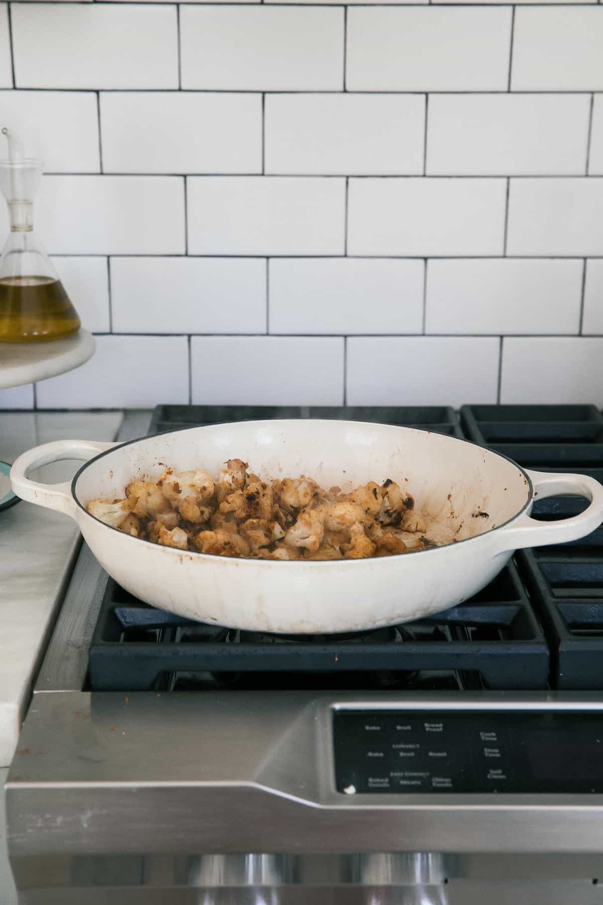 Cauliflower with spices in pan. 