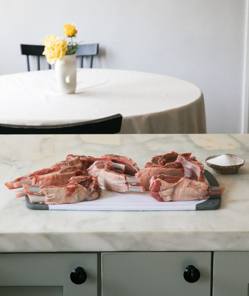 raw lamb chops on cutting board