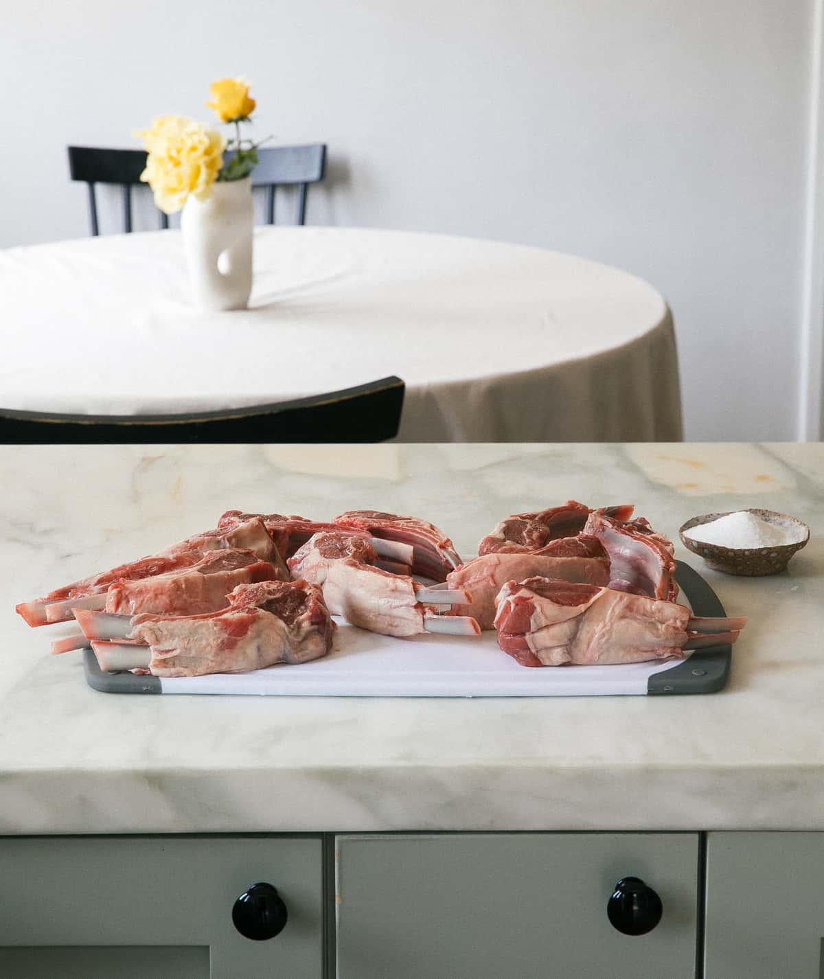 Raw lamb chops on cutting board. 