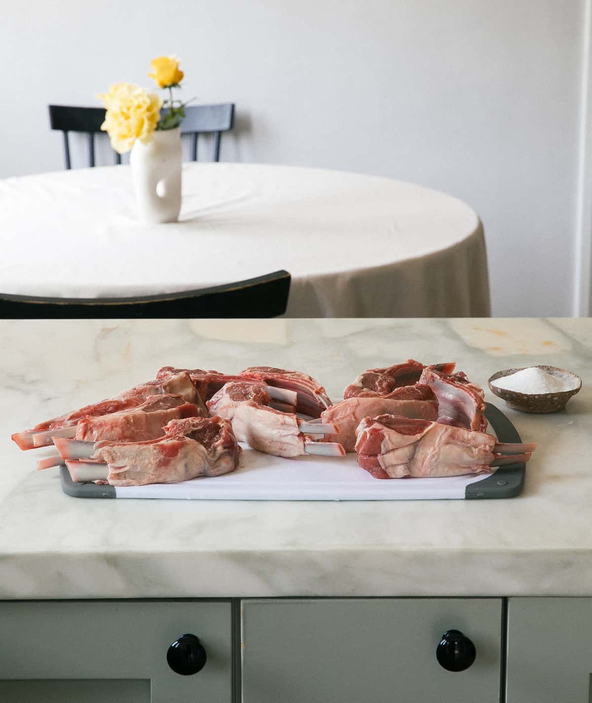 Raw lamb chops on cutting board.