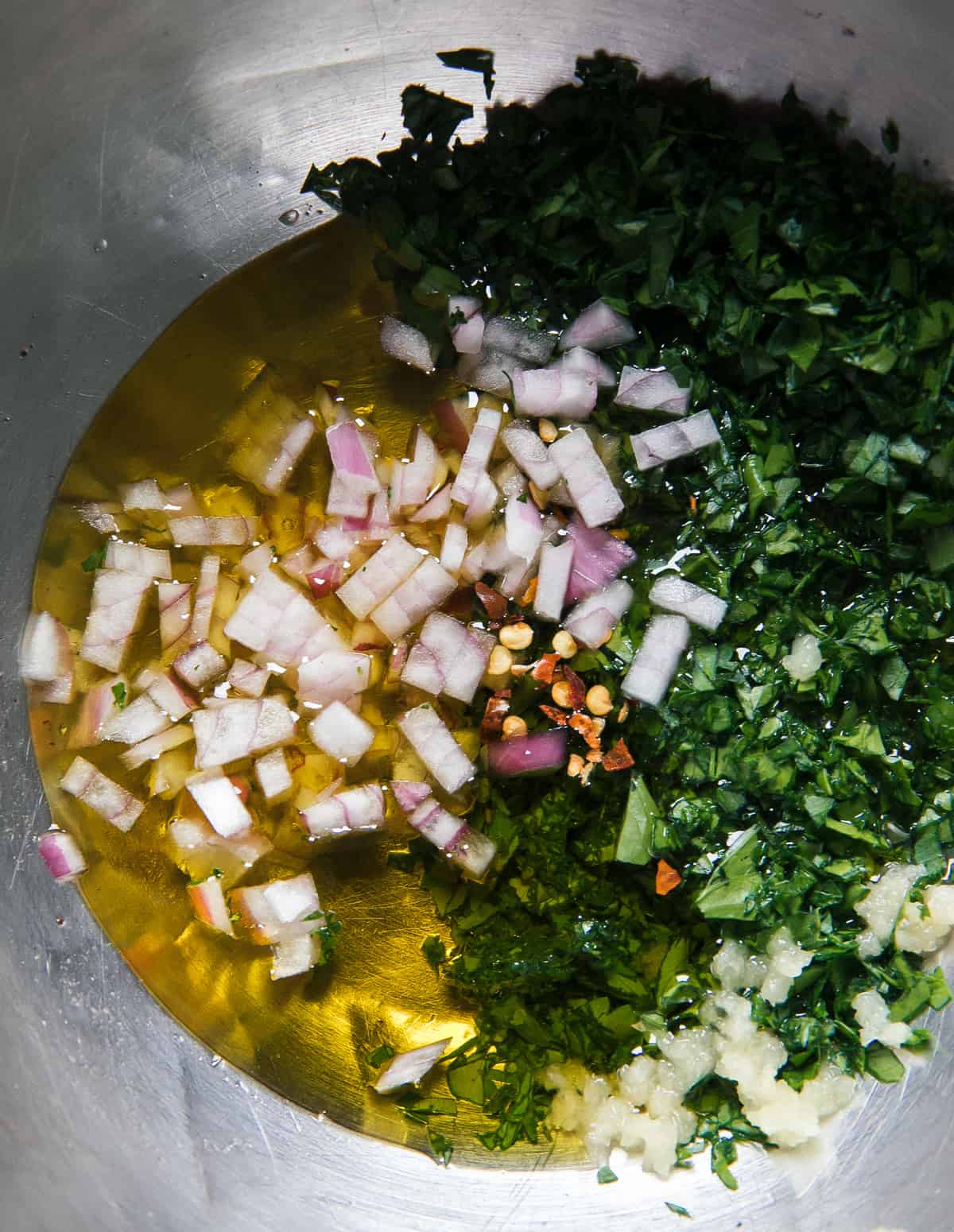 Chimichurri ingredients in bowl.