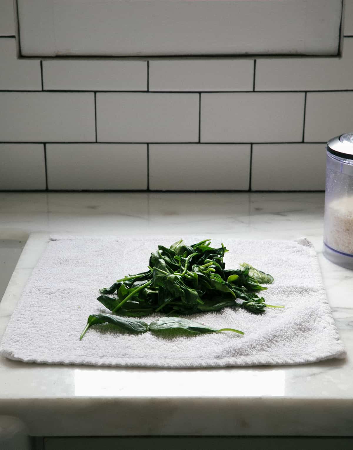 Spinach being drained