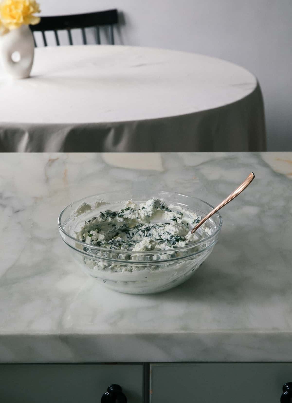 Spinach being mixed with ricotta