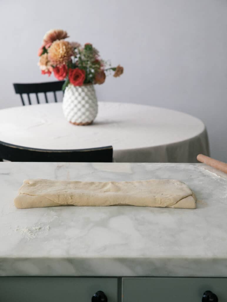 Dough being folded like letter. 