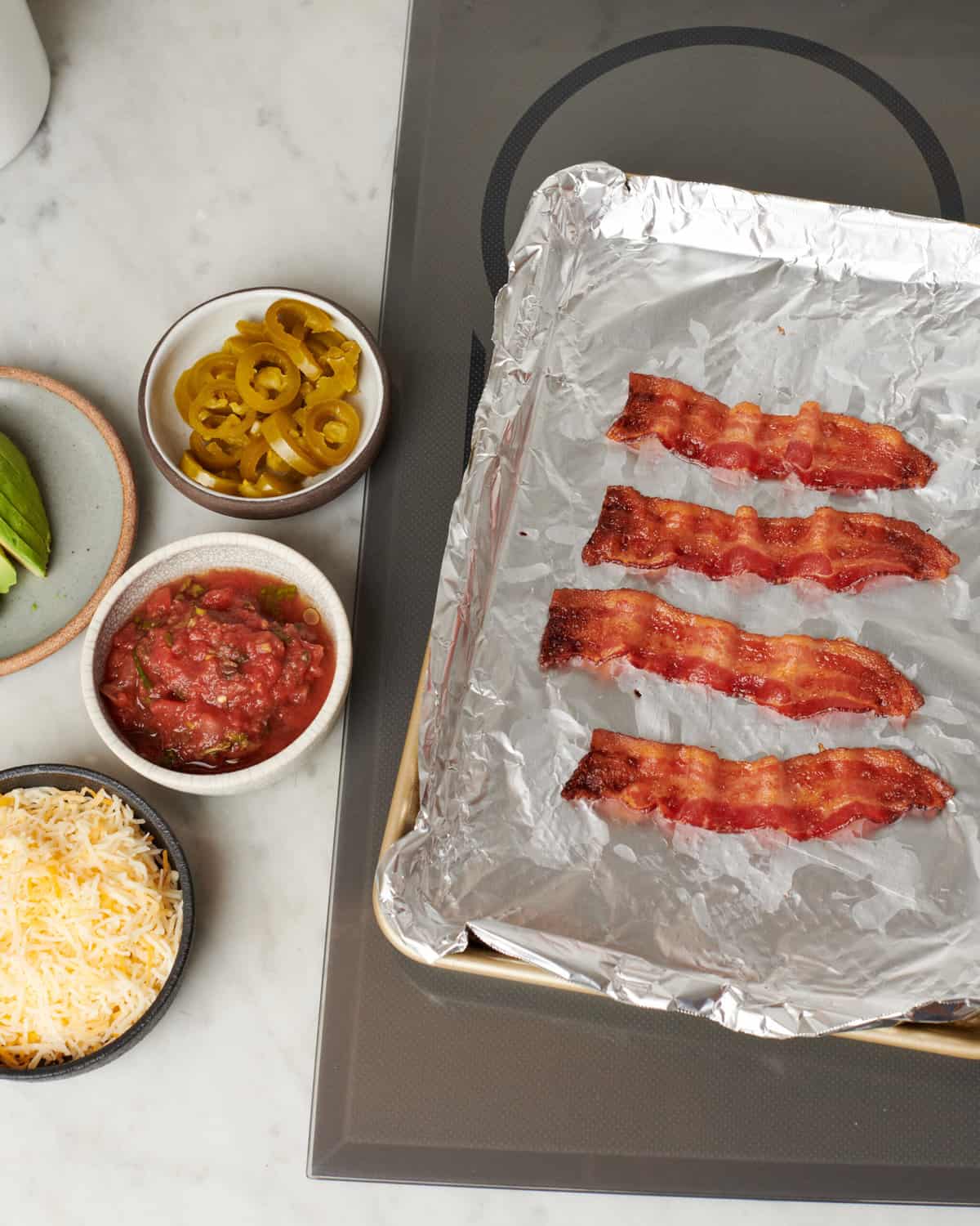 Bacon on a baking sheet. 