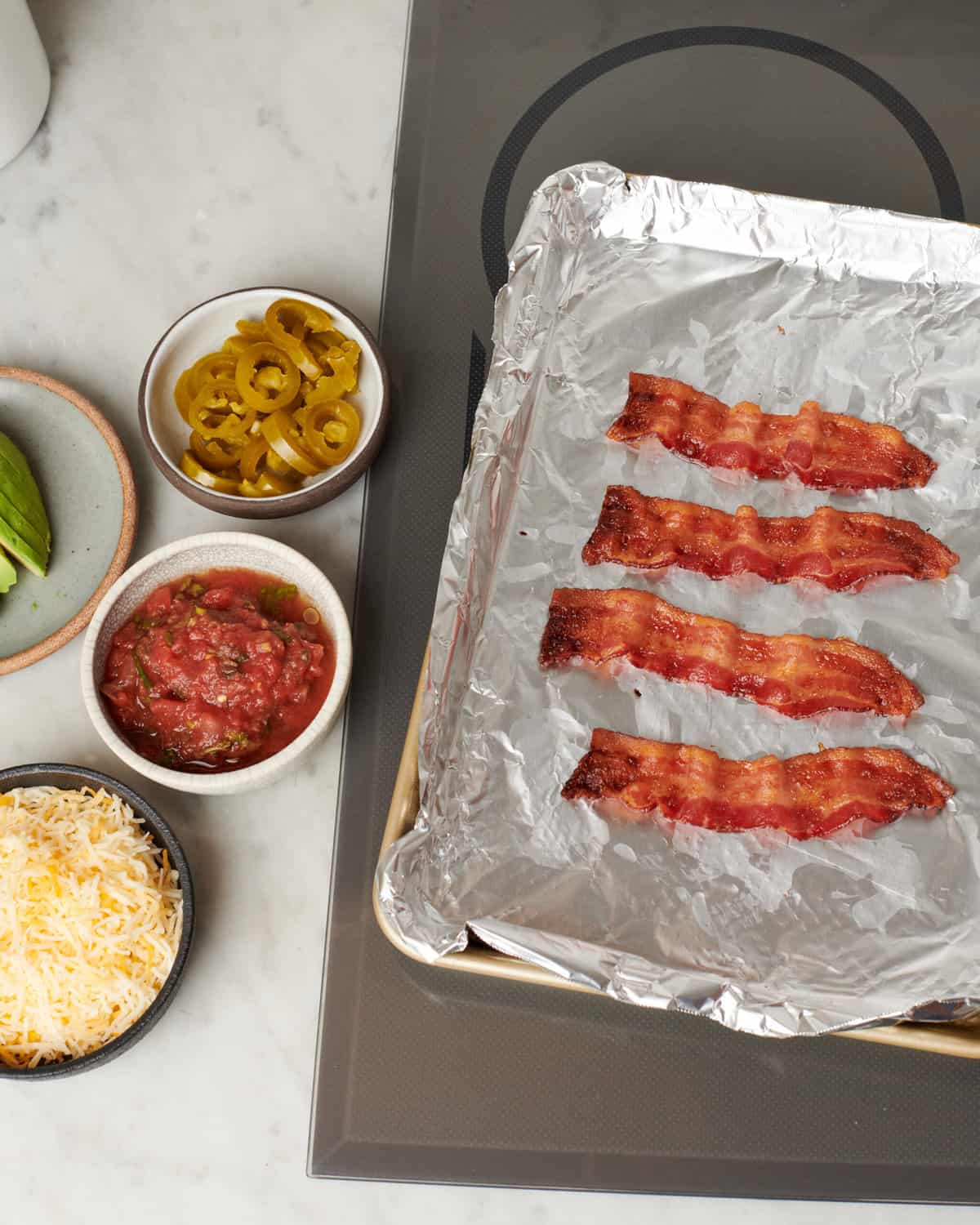 Bacon on a baking sheet.
