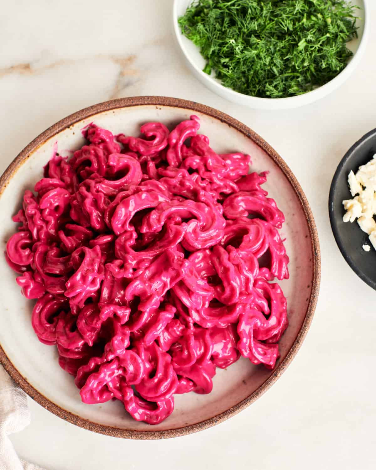 roasted beet and feta pasta being plated