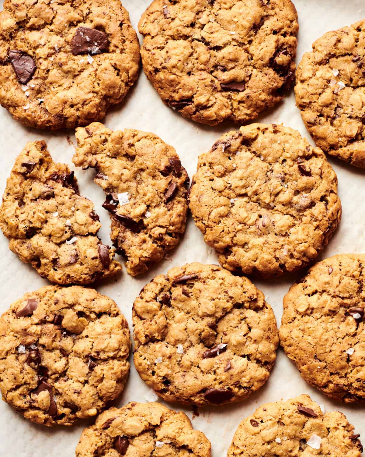 Oatmeal Chocolate Chip Cookies on baking sheet with flakey sea salt. 