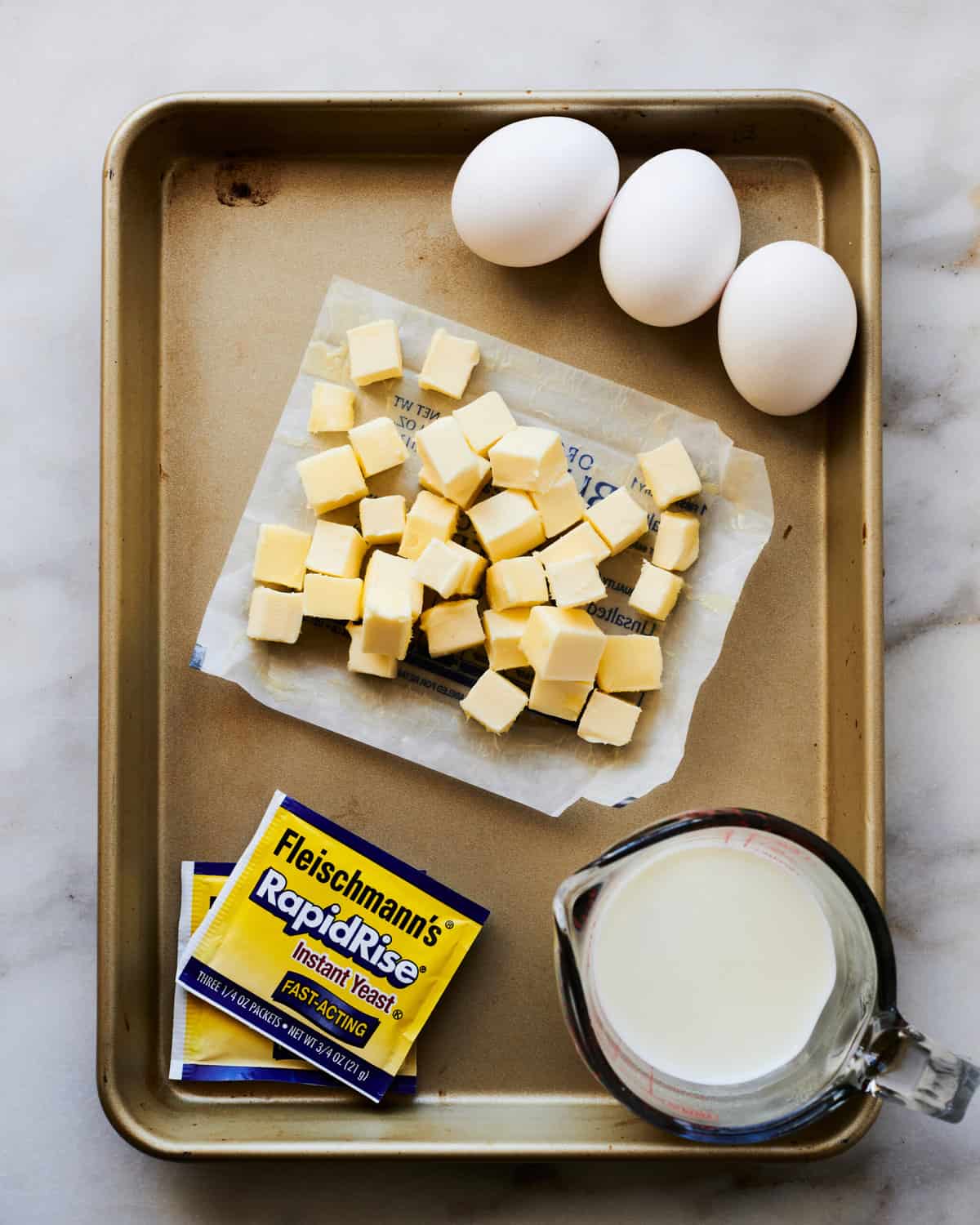 Ingredients for Apple Cinnamon Rolls on a baking sheet.