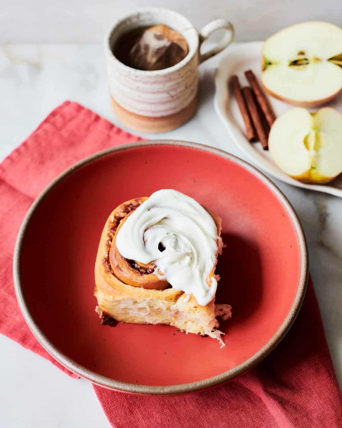 An apple cinnamon roll on a plate.