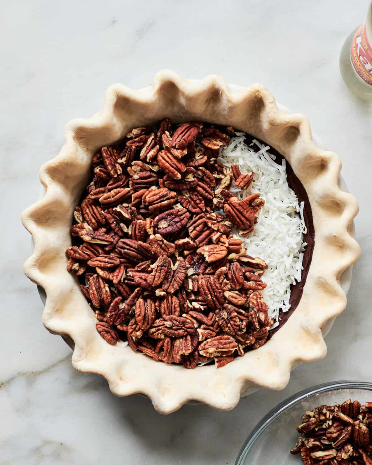 Layering Filling in Chocolate Coconut Pecan Pie.