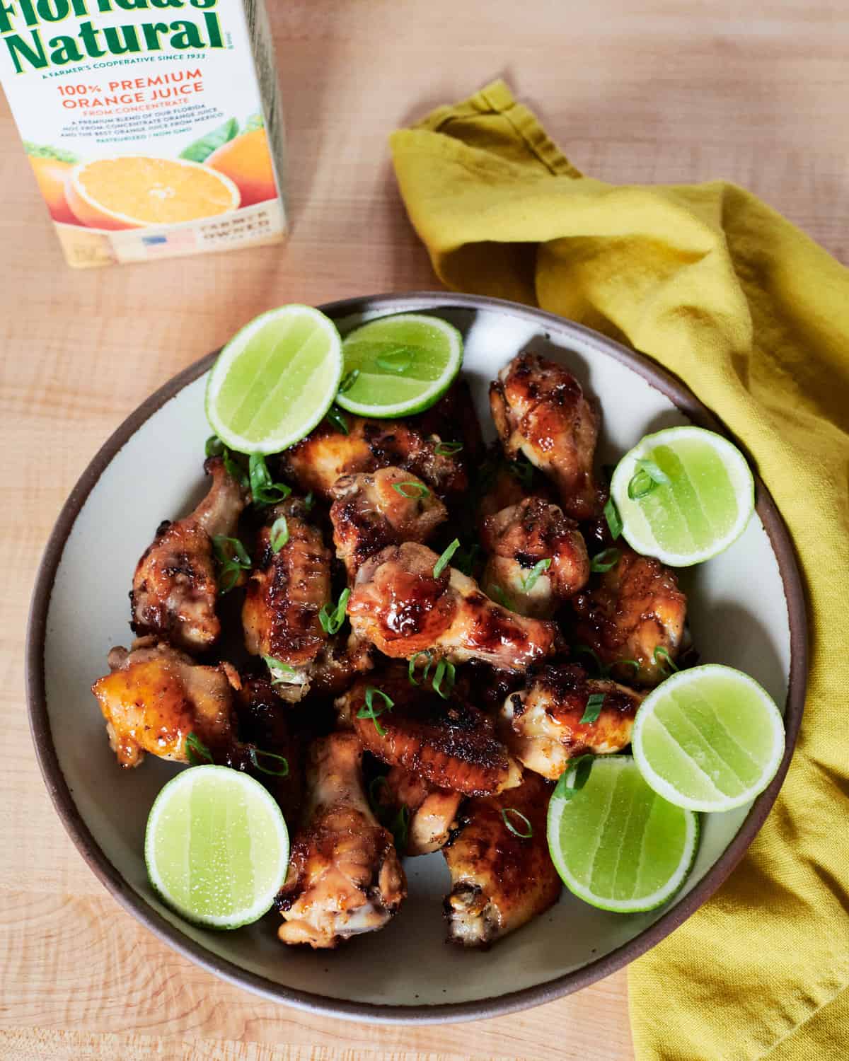 Garlic Chicken Wings in bowl with limes. 