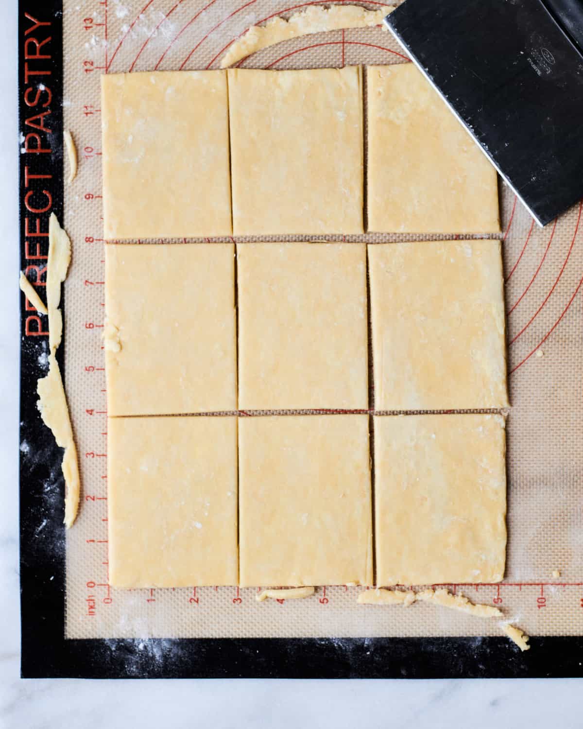 dough being cut into rectangles.