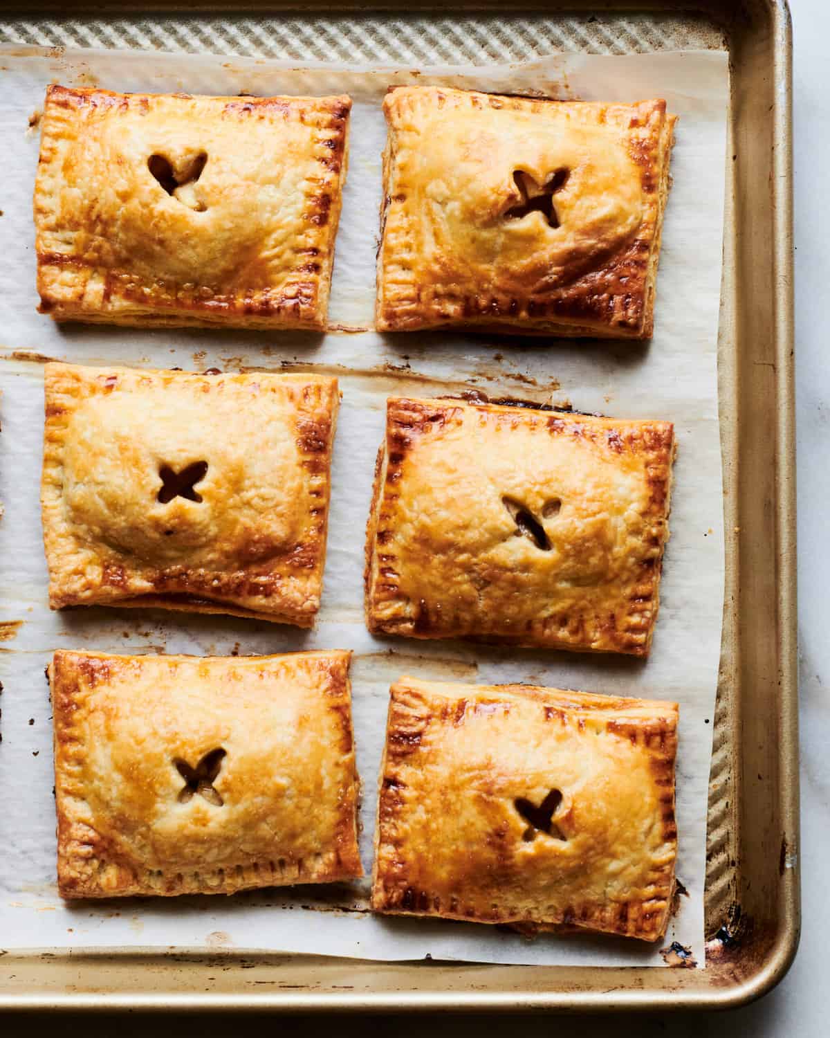 apple hand pies warm and baked on baking sheet.