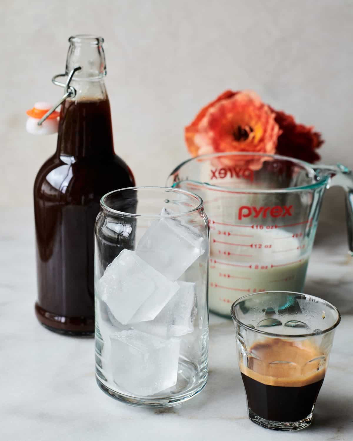 Photo of all the components: pumpkin syrup, milk and espresso