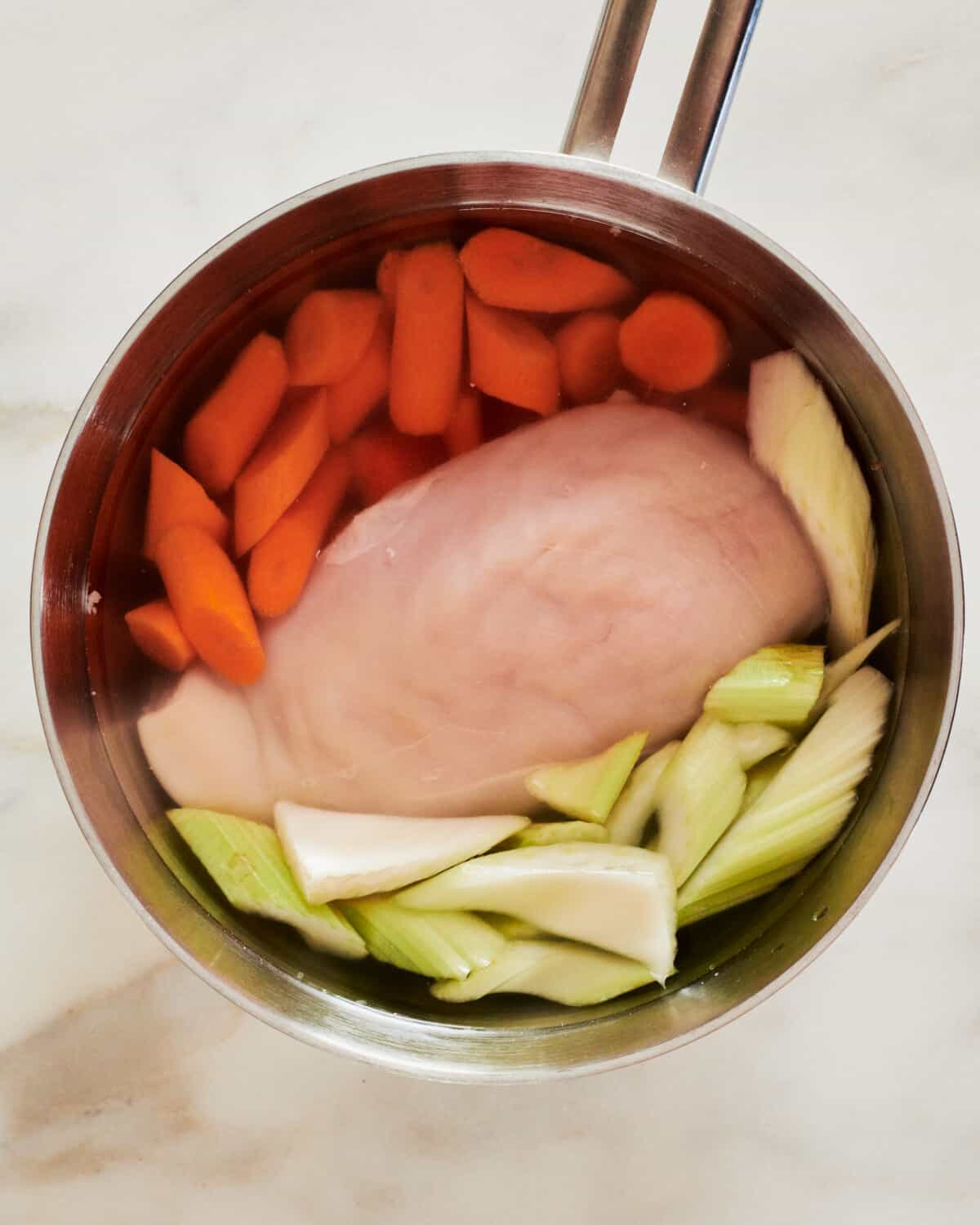 Cooking the chicken in a pot.