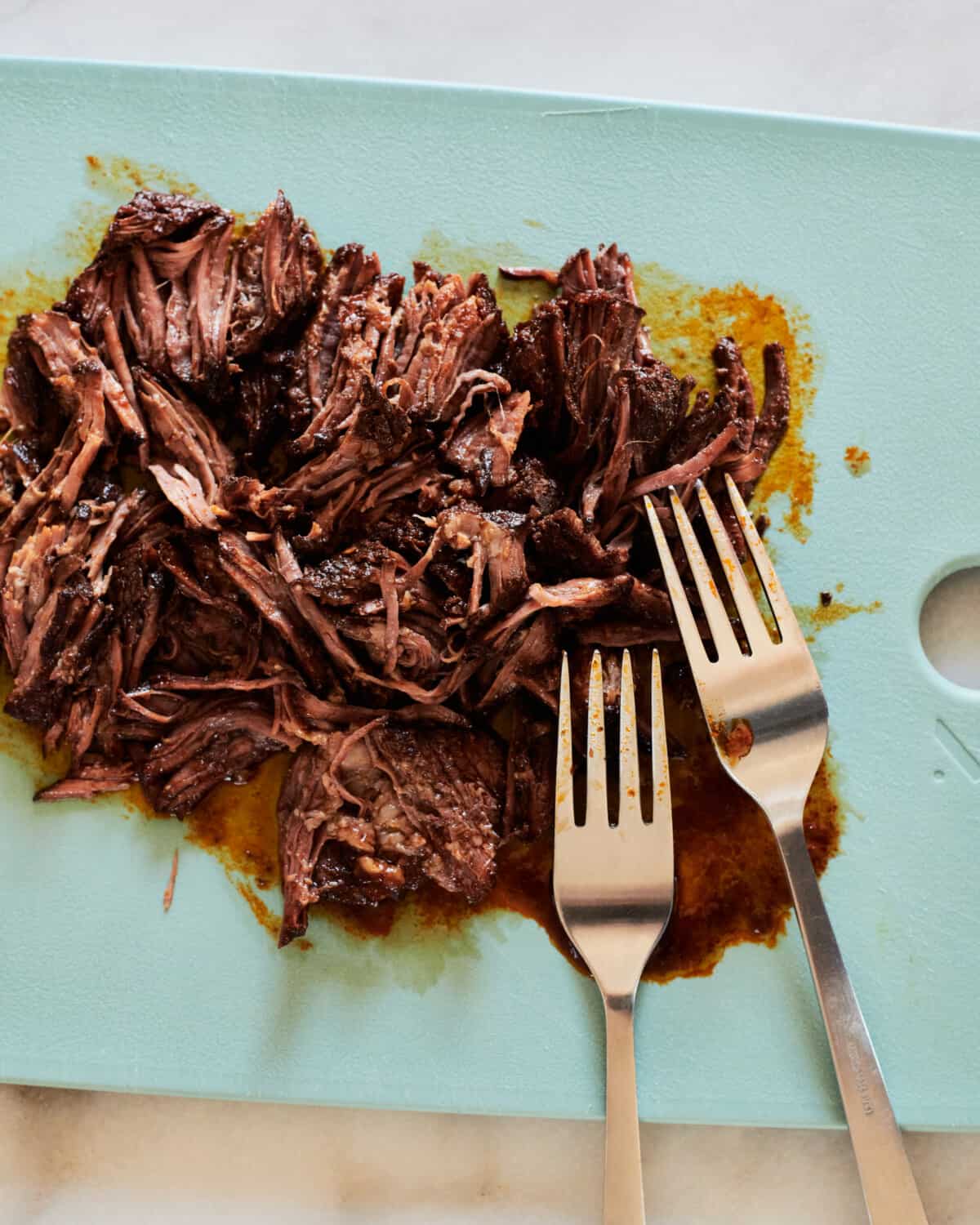 Shredded Beef on cutting board.