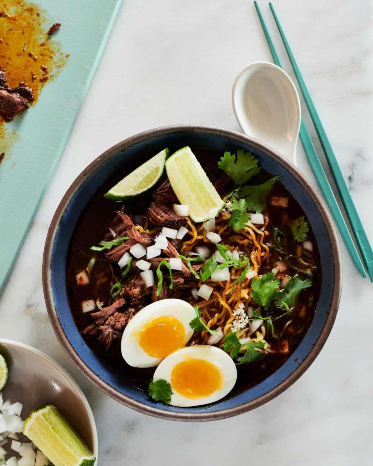 Birria Ramen recipe in bowl with chopsticks on the side. 