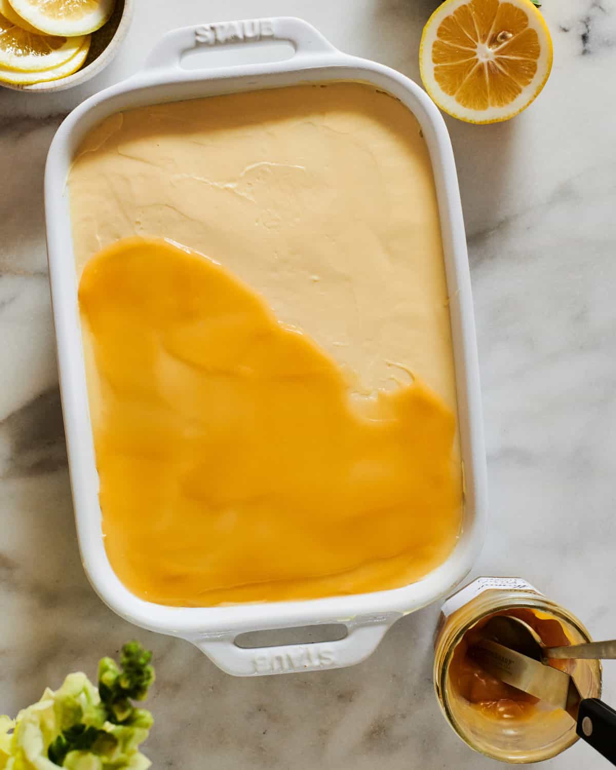 Lemon curd going on top of tiramisu.