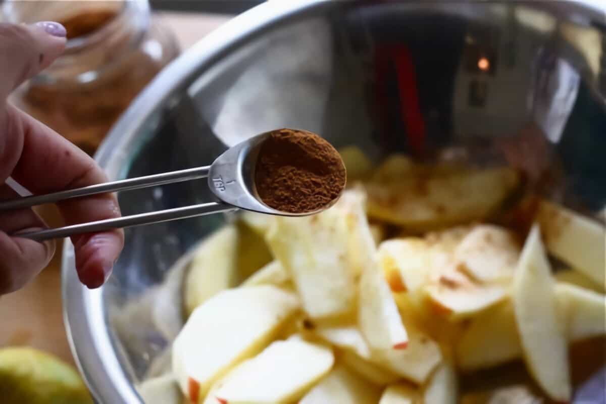 cinnamon being added to apples.