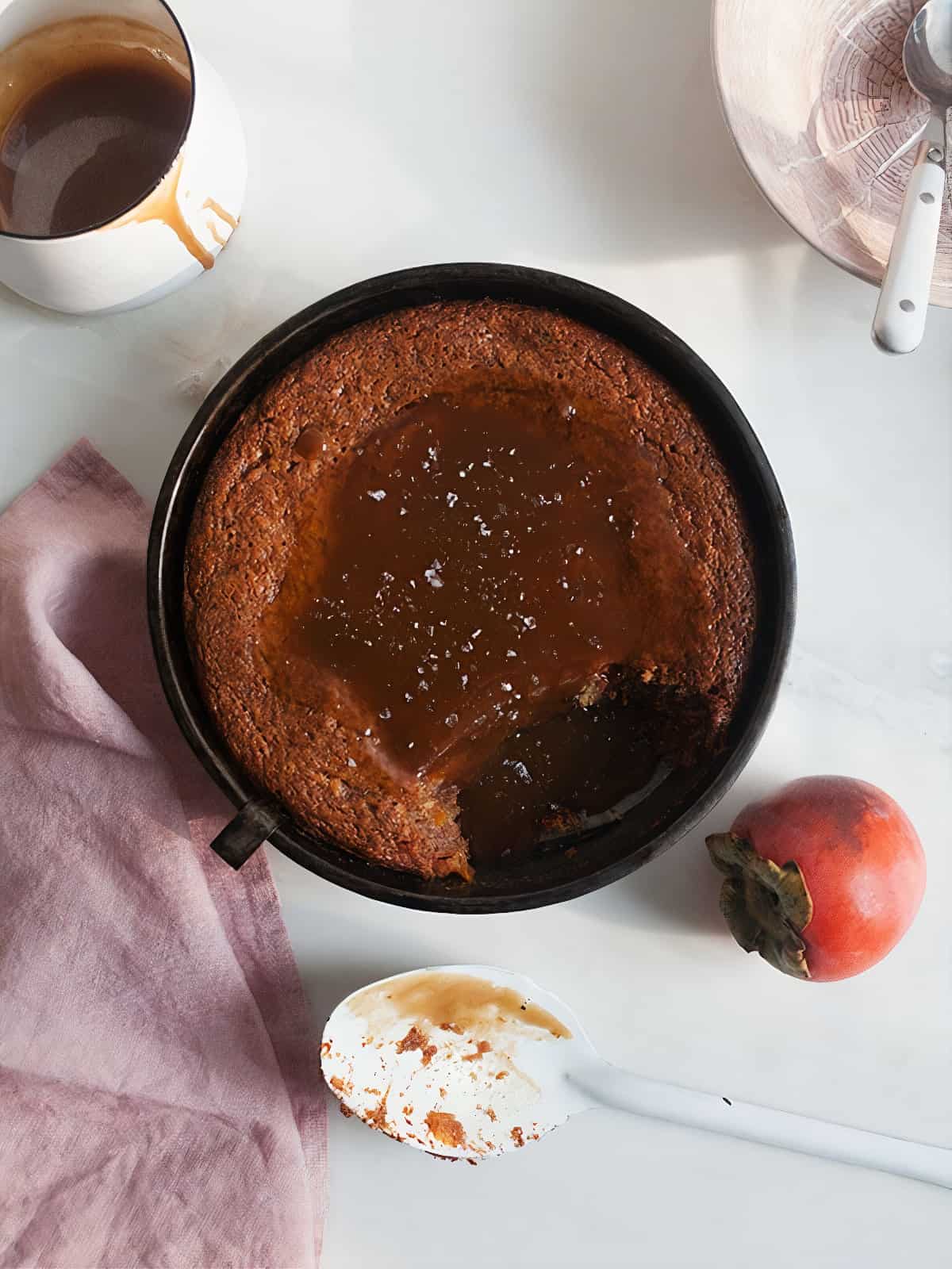 Sticky Toffee Persimmon Pudding with a scoop taken out. 