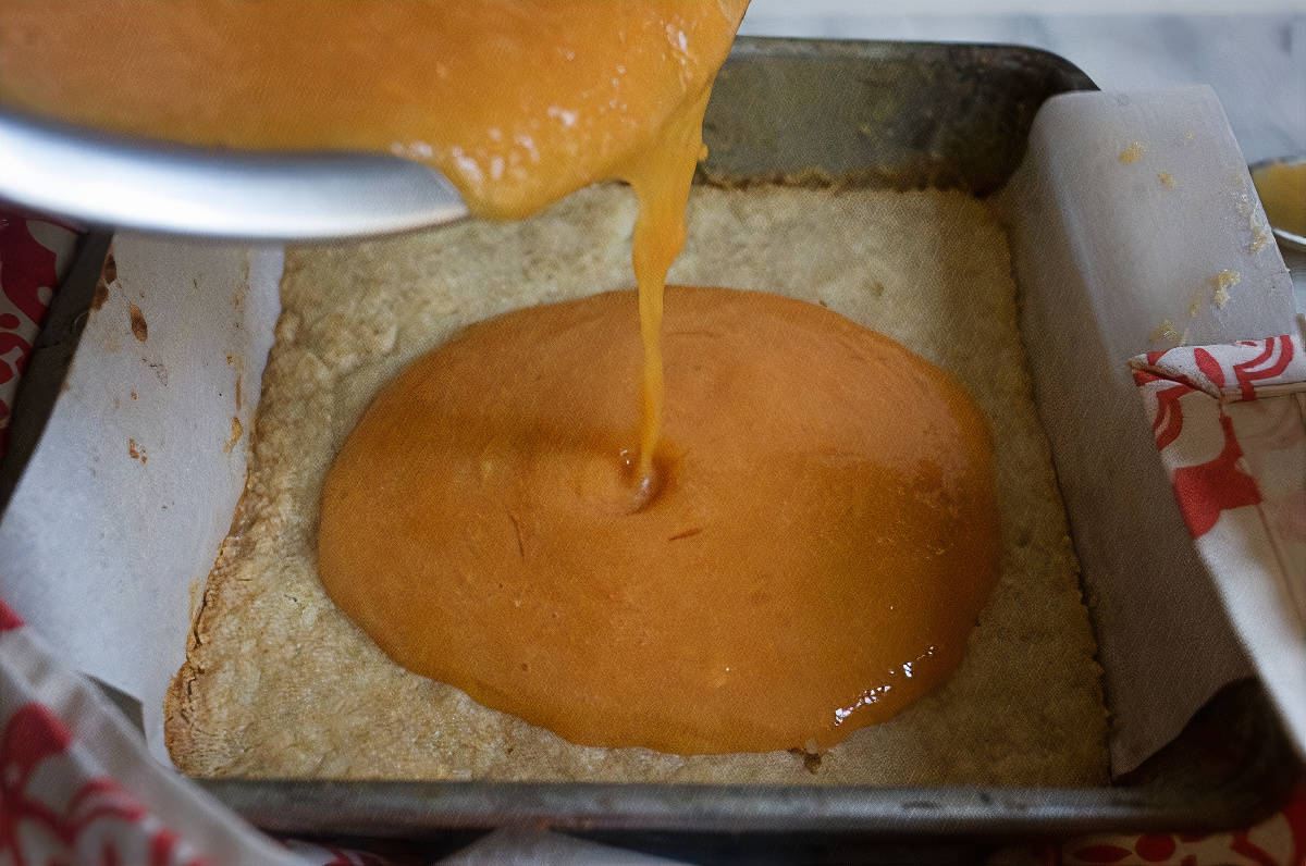 Filling being poured into pan.