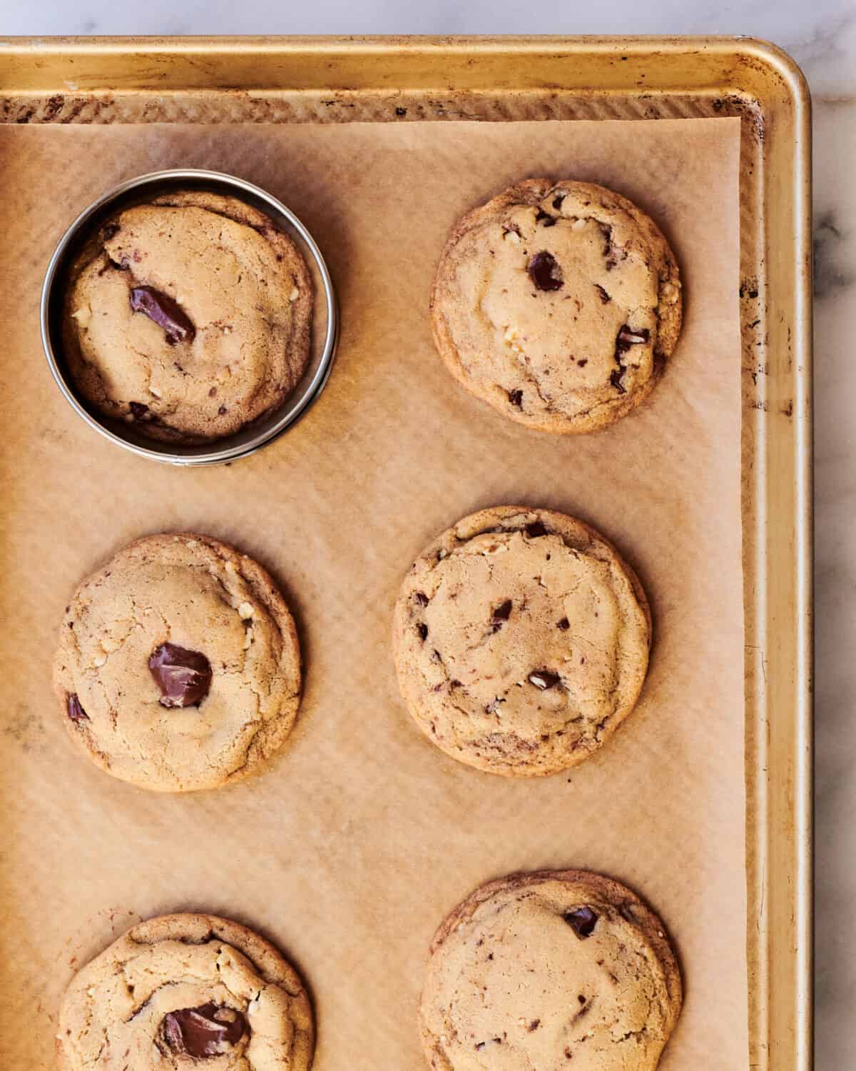 Brown butter chocolate chip cookies on a baking sheet.