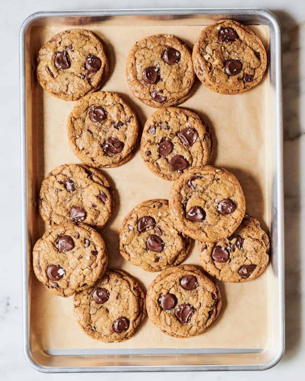 Brown butter chocolate chip cookies on a baking sheet. 