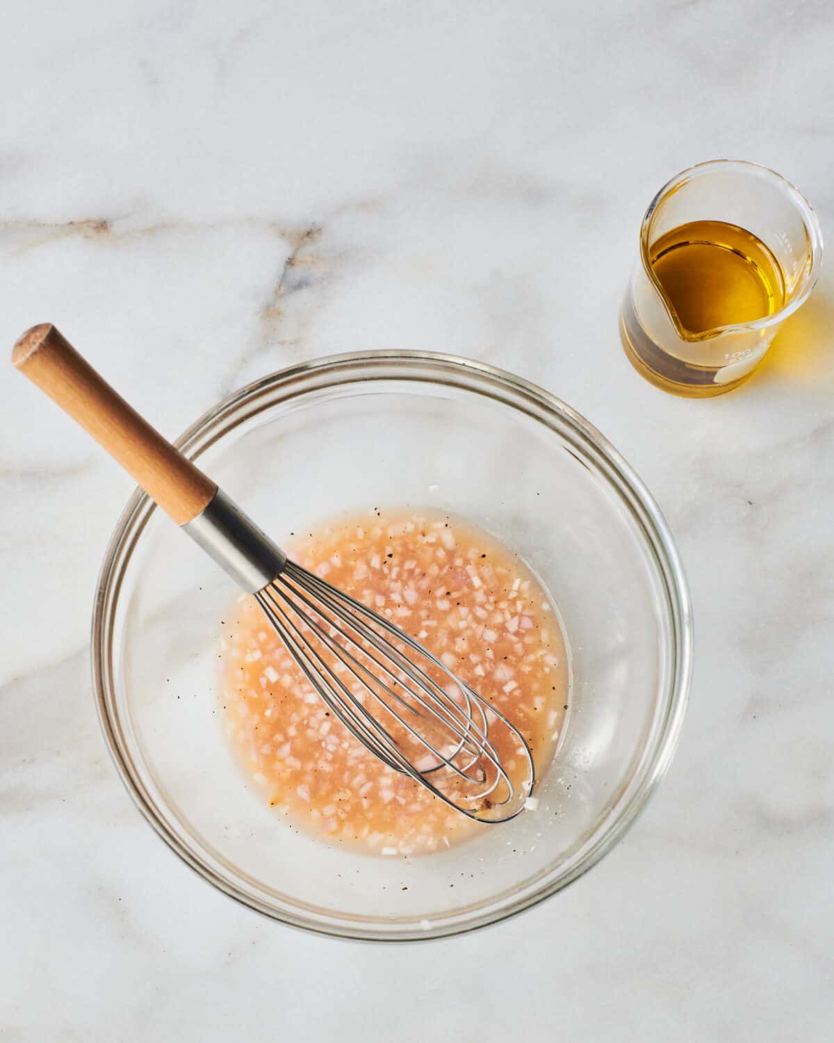 Shallot dressing being mixed up in a bowl. 