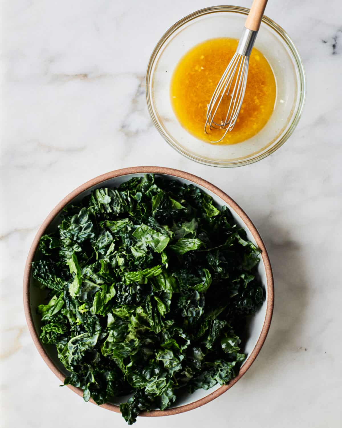 Kale in bowl with the dressing on the side. 