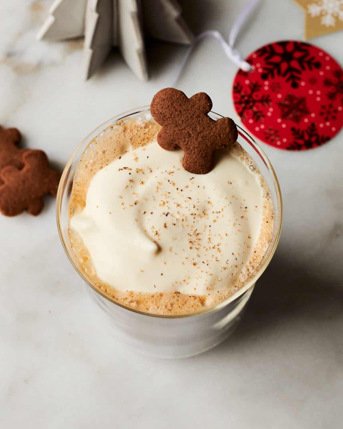 Gingerbread latte in mug with a cookie. 