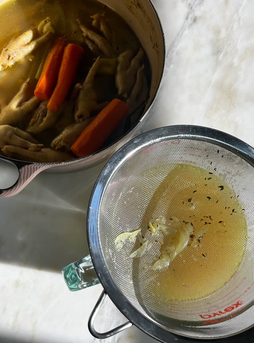 Straining the chicken stock. 