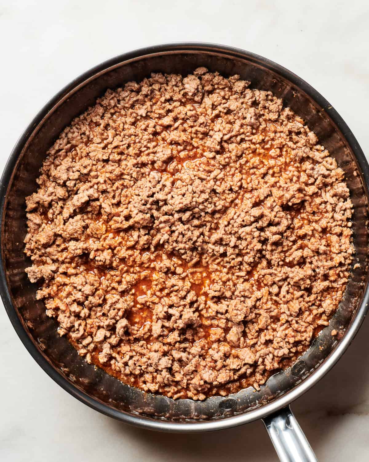 Ground beef cooked in a pan with spices. 