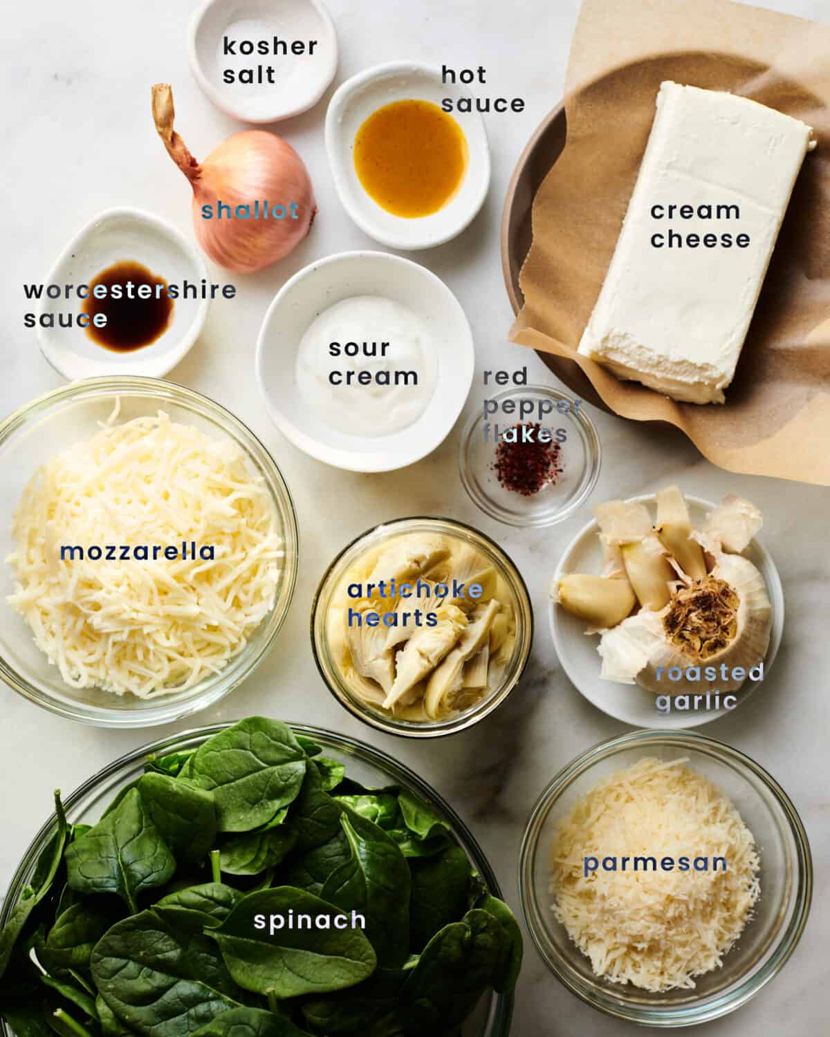 Ingredients for Spinach Artichoke Dip in small bowls. 