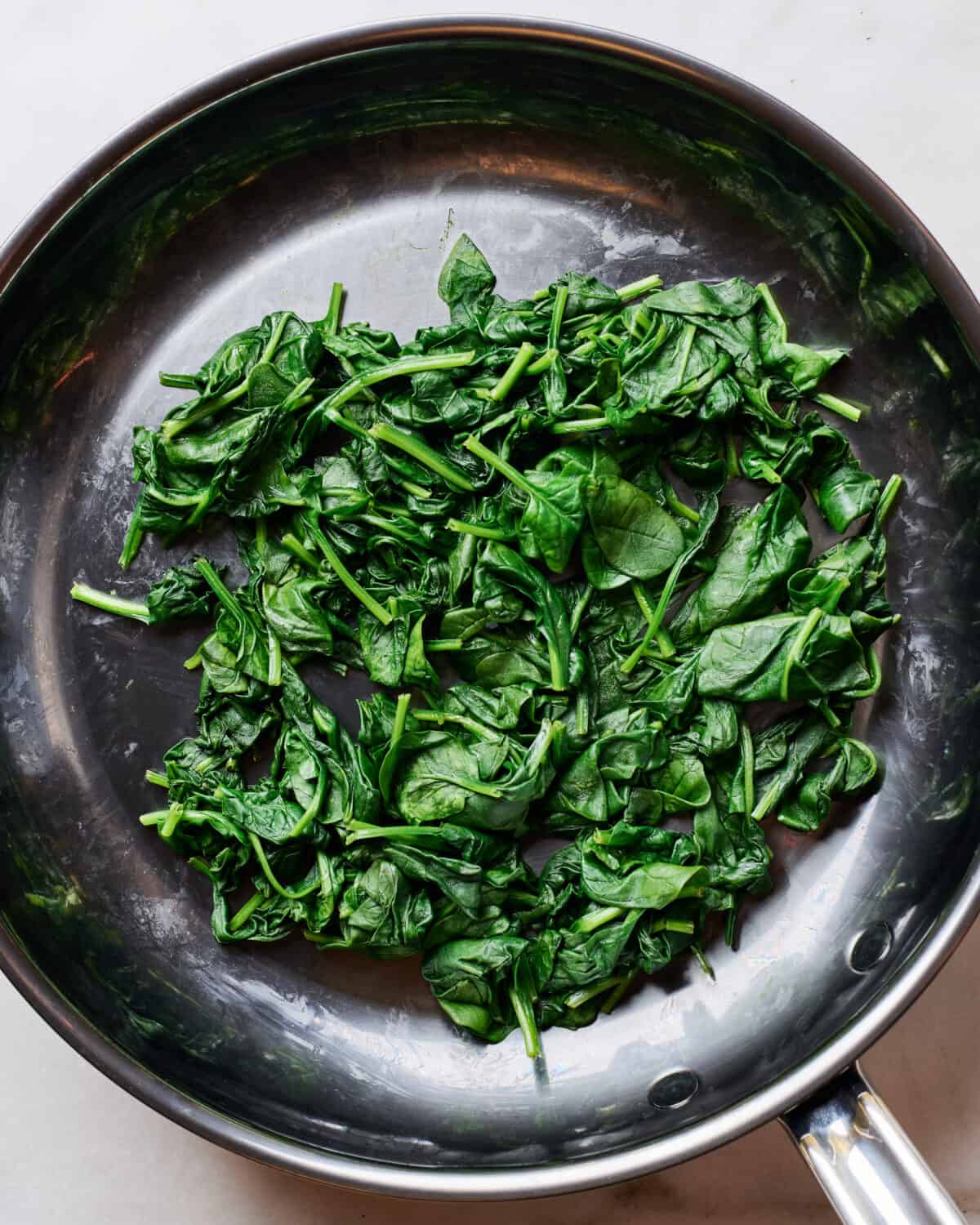 Spinach wilted in a pan. 