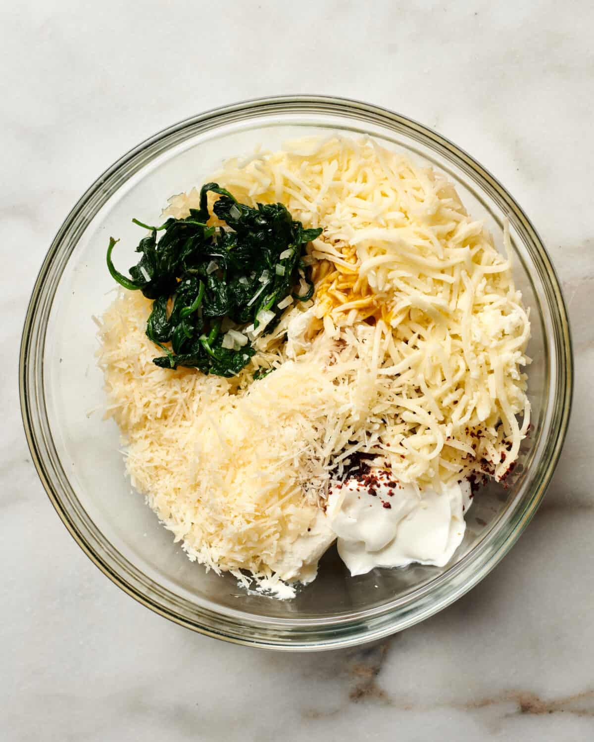 Bowl of spinach dip being mixed together. 