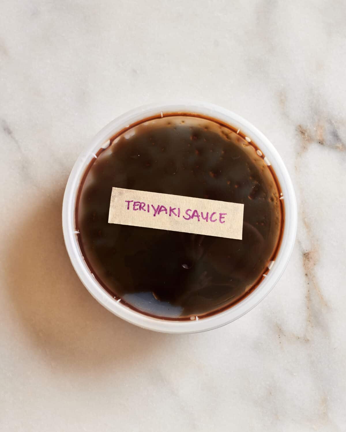 Teriyaki sauce in a quart container. 