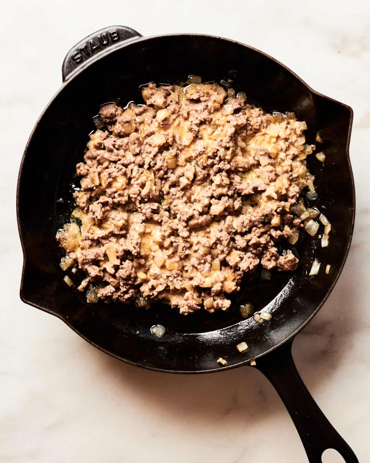 Ground beef all mixed up in a pan. 
